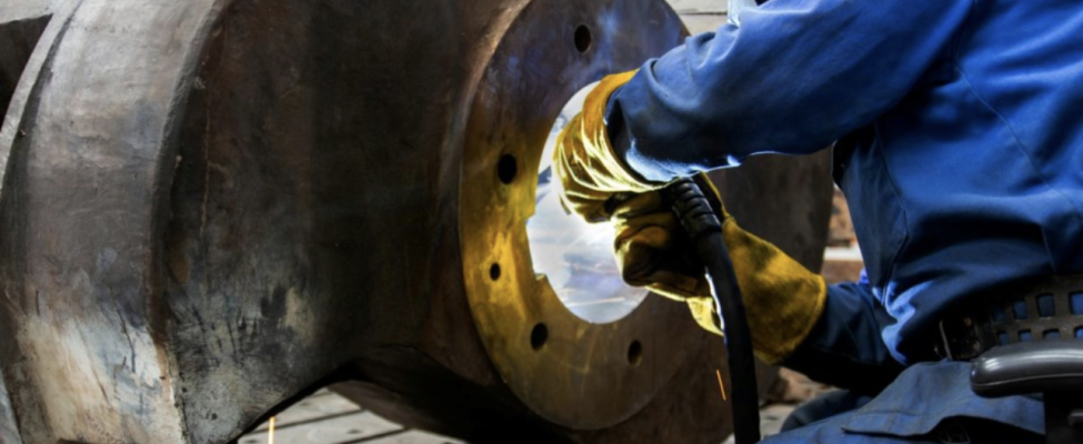 Tradesperson welding a large metal object
